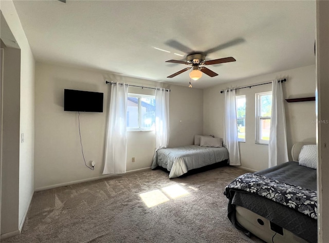 bedroom with carpet floors, multiple windows, and ceiling fan