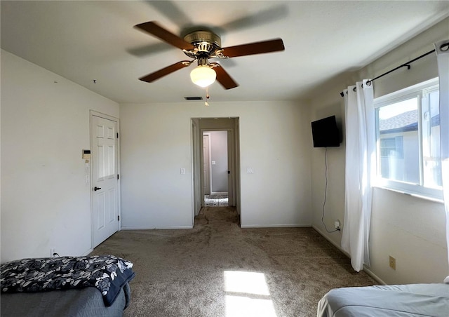 bedroom featuring ceiling fan and carpet