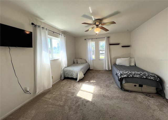 carpeted bedroom with multiple windows and ceiling fan