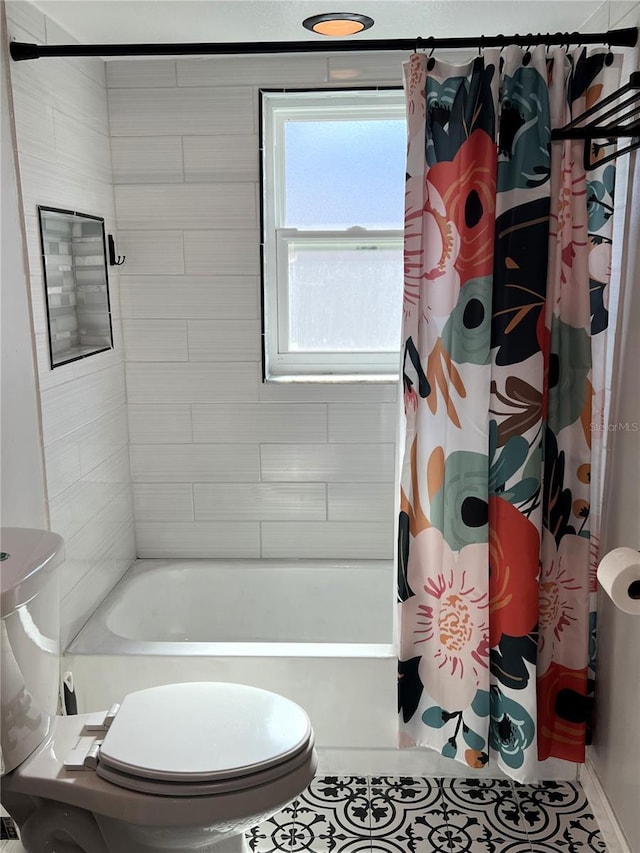 bathroom with tile patterned floors, shower / bath combo, and toilet