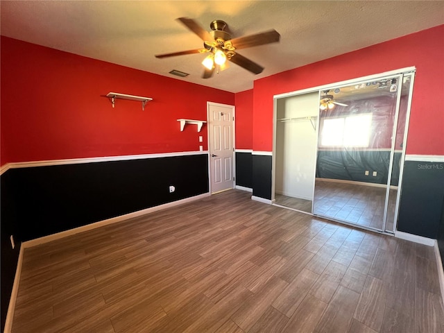 1196 Hinton St, Port Charlotte, FL 33952 - unfurnished bedroom featuring wood finished floors, a ceiling fan, and a closet