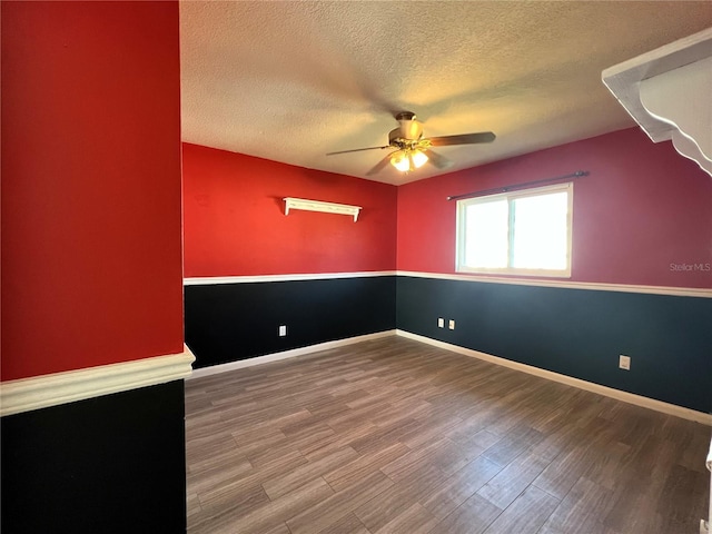 empty room featuring a textured ceiling, hardwood / wood-style flooring, and ceiling fan