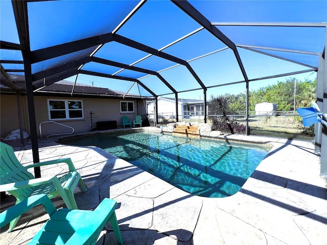 view of swimming pool with a lanai and a patio area