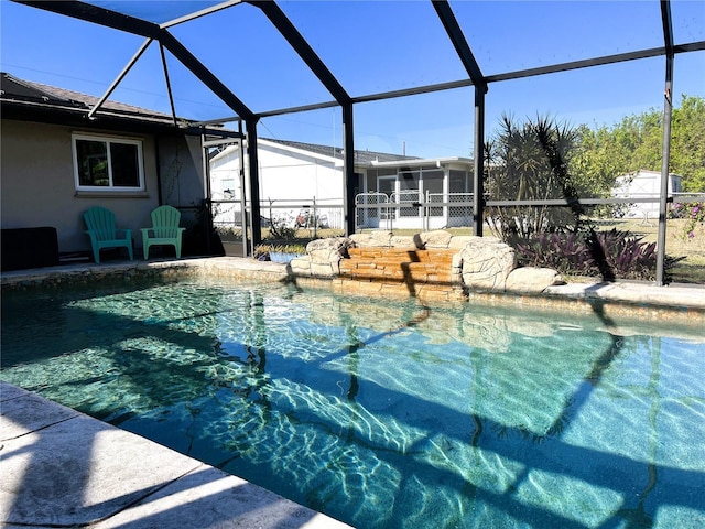 view of swimming pool with glass enclosure