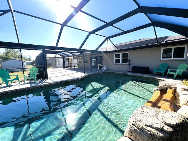 view of swimming pool with a patio and a lanai