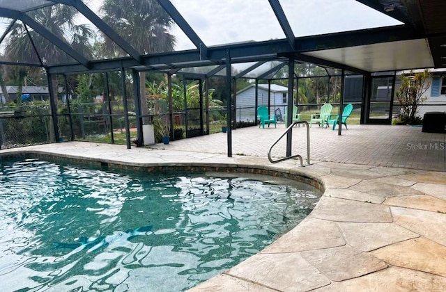 1196 Hinton St, Port Charlotte, FL 33952 - pool with an outbuilding, glass enclosure, a storage shed, and a patio area