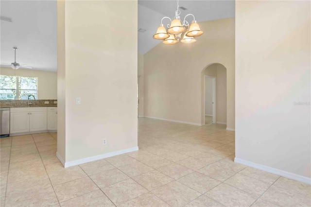 tiled spare room featuring ceiling fan with notable chandelier, sink, and high vaulted ceiling