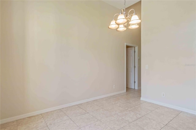 empty room with an inviting chandelier and light tile patterned flooring