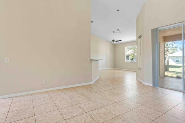 spare room with ceiling fan and light tile patterned flooring