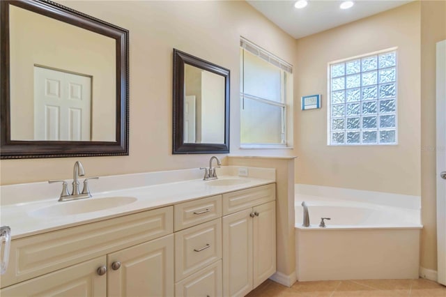 bathroom featuring tile patterned flooring, vanity, and a tub