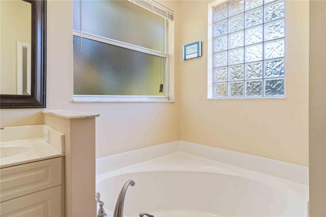 bathroom featuring vanity and a tub to relax in