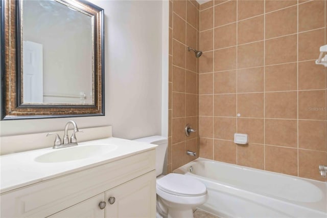 full bathroom featuring vanity, toilet, and tiled shower / bath