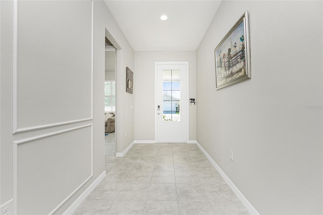 doorway with light tile patterned flooring