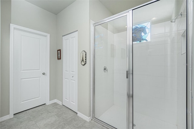 bathroom with tile patterned floors and walk in shower