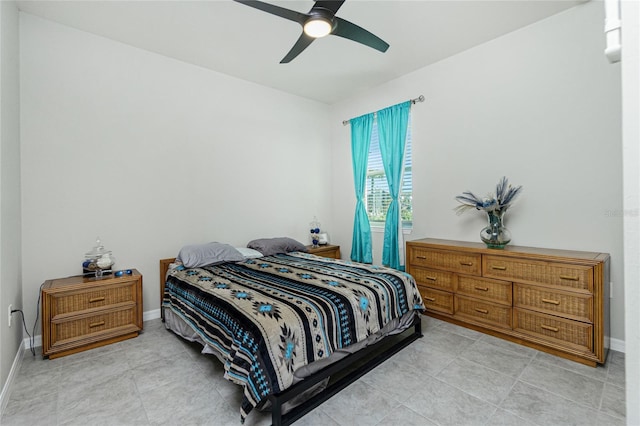 bedroom with ceiling fan and light tile patterned floors