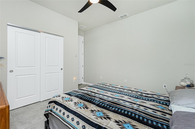 bedroom with ceiling fan, a closet, and light tile patterned flooring