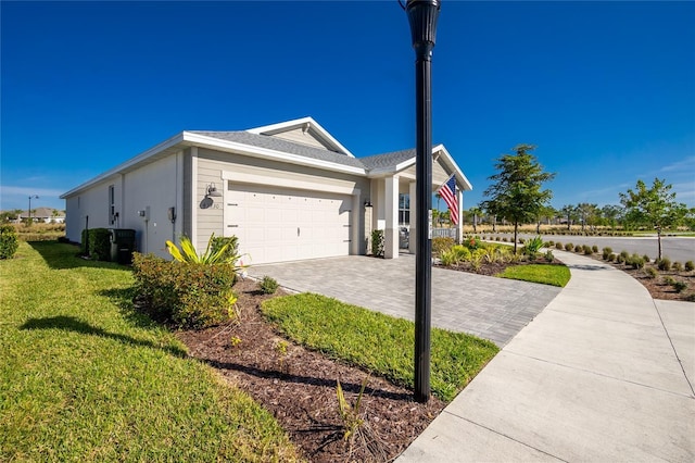 view of side of home with a lawn and a garage