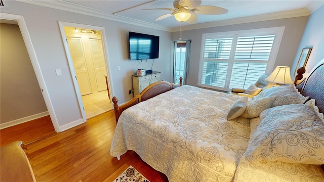 bedroom featuring ceiling fan, wood-type flooring, and crown molding