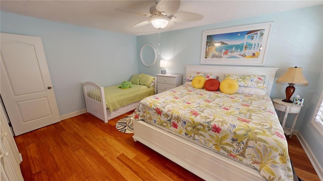 bedroom with ceiling fan and wood-type flooring