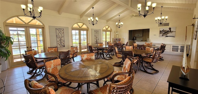 dining space with plenty of natural light, beam ceiling, high vaulted ceiling, and french doors