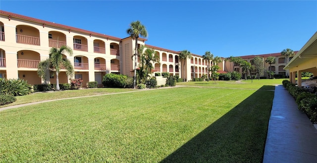 view of property's community with a lawn