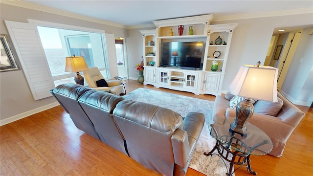 living room featuring crown molding and light hardwood / wood-style floors