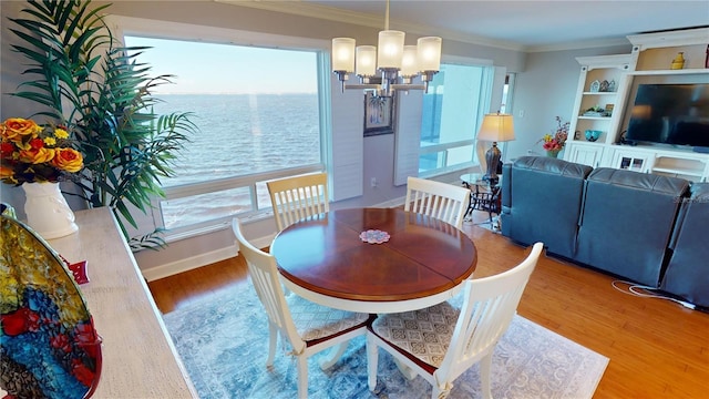 dining room featuring ornamental molding, a chandelier, and hardwood / wood-style flooring