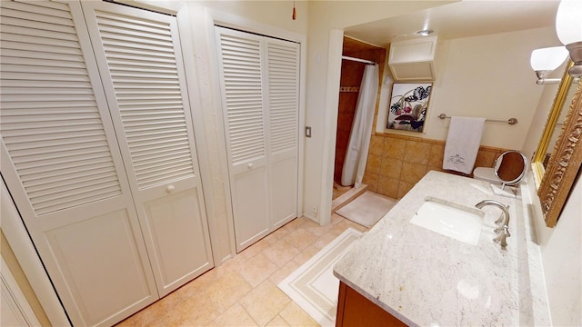 bathroom with tile patterned flooring, vanity, and curtained shower