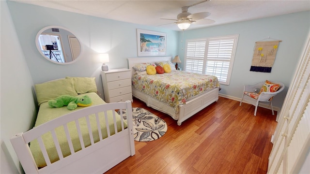 bedroom with light hardwood / wood-style flooring and ceiling fan