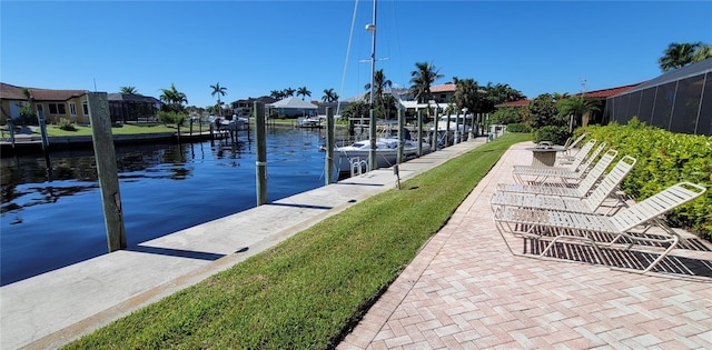 view of dock featuring a lawn and a water view