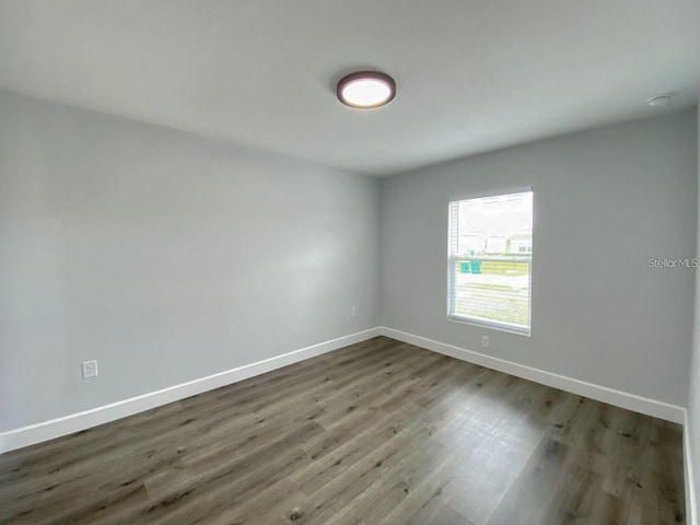 spare room with dark hardwood / wood-style floors