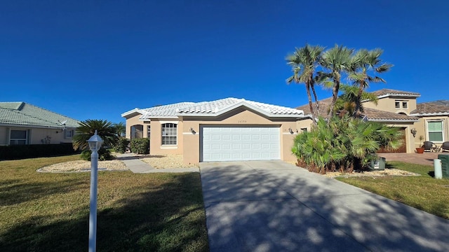 mediterranean / spanish-style home with a front yard and a garage