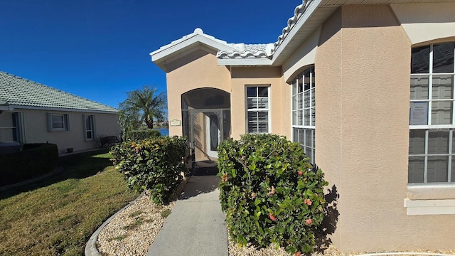 doorway to property featuring a yard