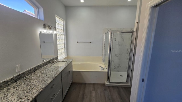 bathroom with wood-type flooring, vanity, and separate shower and tub