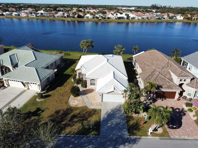 birds eye view of property with a water view