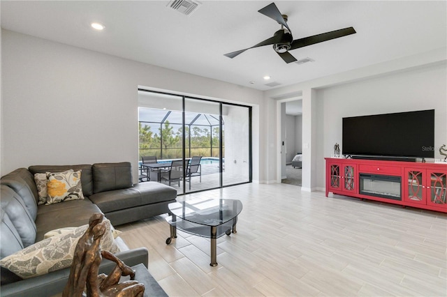 living room featuring light wood-type flooring and ceiling fan