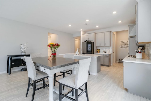 dining space featuring light hardwood / wood-style flooring and sink