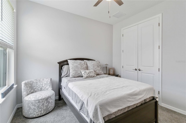 bedroom with carpet flooring, a closet, multiple windows, and ceiling fan