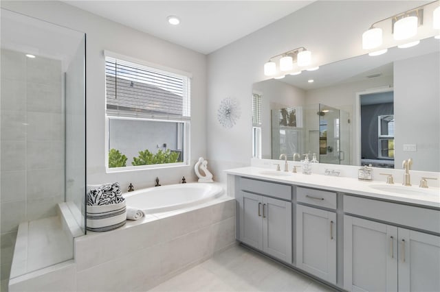 bathroom with plus walk in shower, vanity, and tile patterned floors