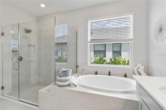 bathroom featuring shower with separate bathtub and vanity