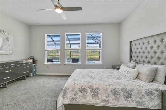 carpeted bedroom with multiple windows and ceiling fan