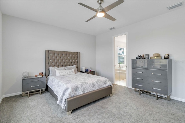 bedroom featuring ceiling fan, light colored carpet, and ensuite bathroom