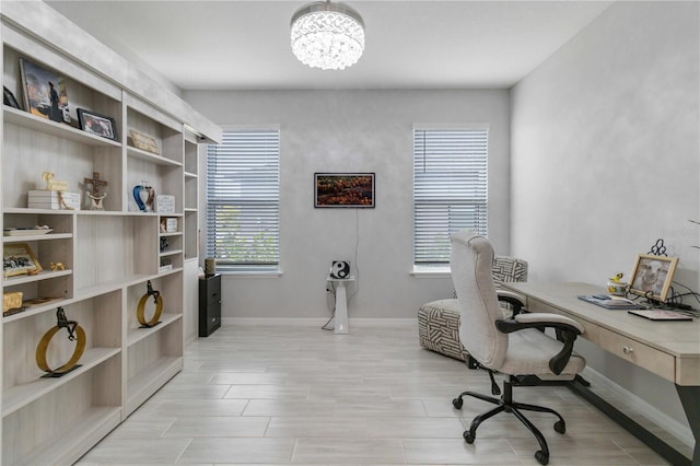 office space featuring a chandelier and light hardwood / wood-style floors