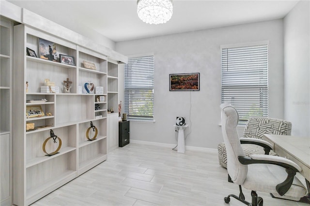 office with a chandelier and light hardwood / wood-style flooring