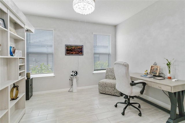 office area featuring light hardwood / wood-style flooring and a chandelier