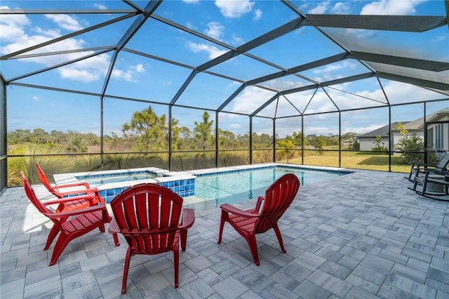 view of swimming pool featuring an in ground hot tub, a patio, and a lanai