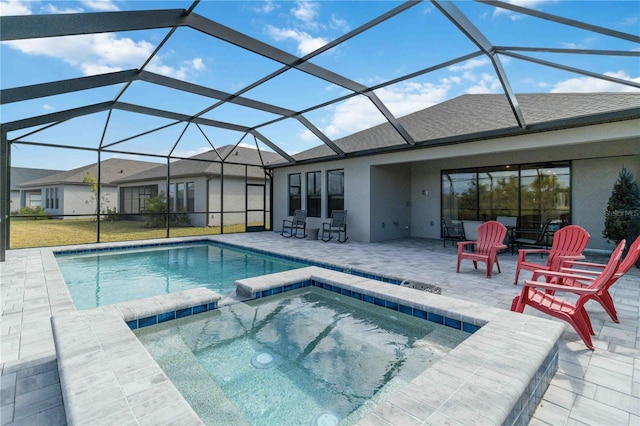 view of swimming pool featuring a lanai, a patio area, and an in ground hot tub