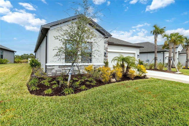 view of front facade with a garage and a front lawn