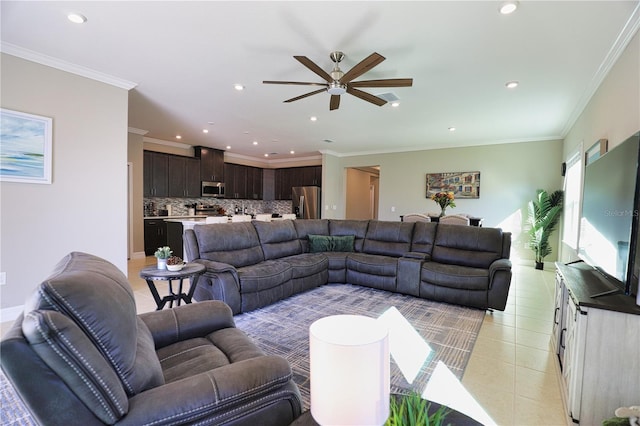 living room with light tile patterned floors, ceiling fan, and ornamental molding