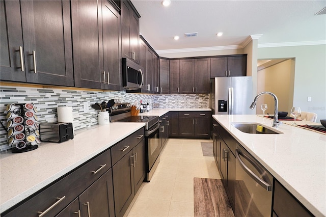 kitchen with sink, decorative backsplash, dark brown cabinets, light tile patterned flooring, and stainless steel appliances